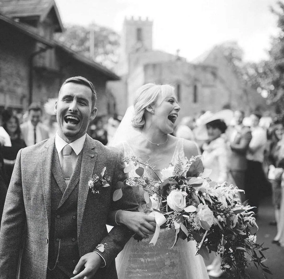 A bride and groom laughing together at Yorkshire Wedding Barn