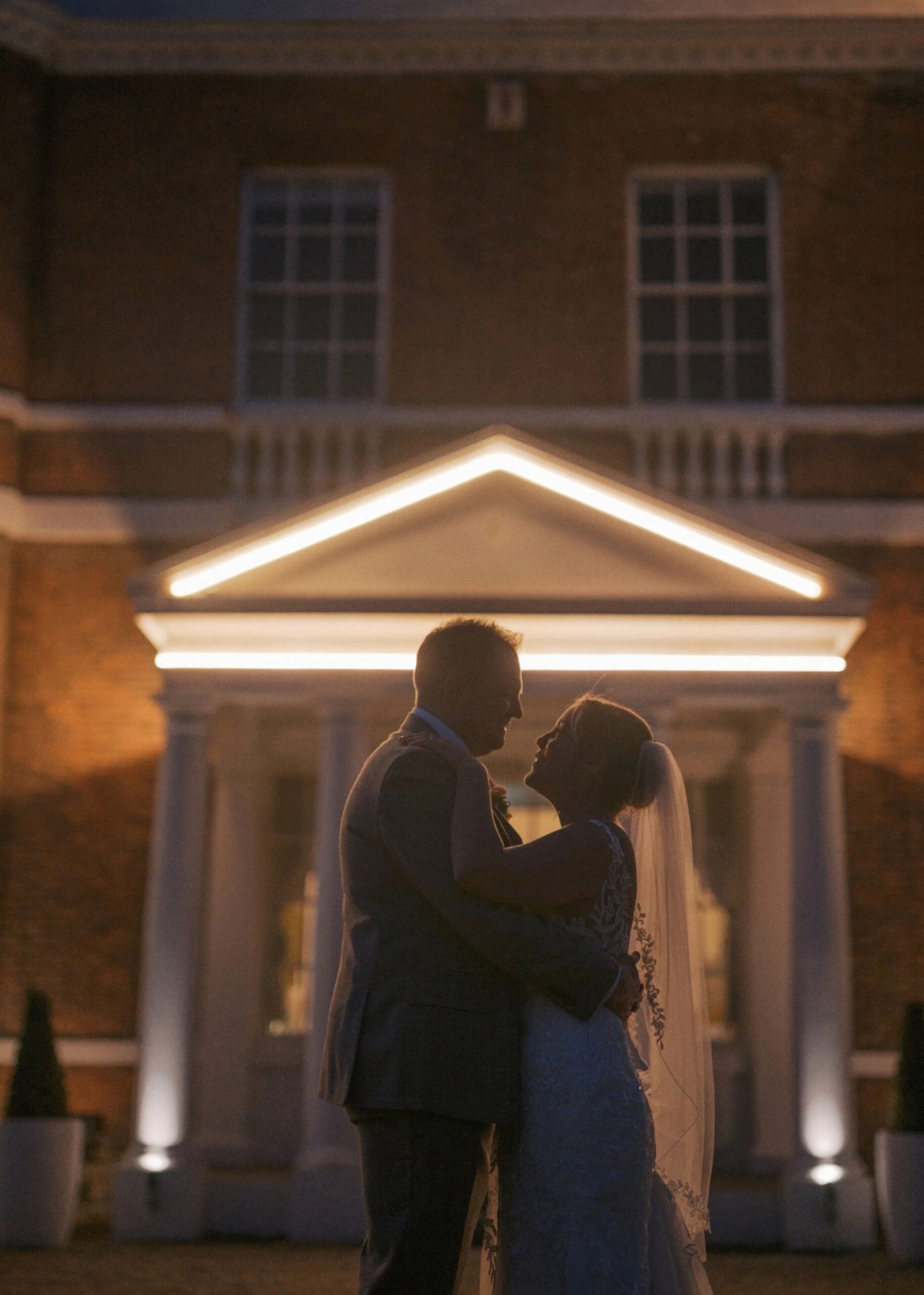 Couple embracing in romantic evening light. Taken by a bawtry hall wedding photographer