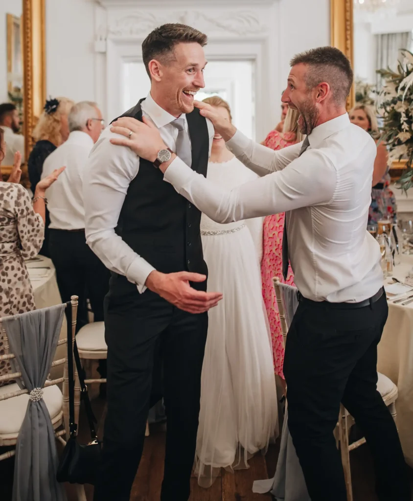BAWTRY HALL WEDDING PHOTOGRAPHER groom laughing with friend during recpetion