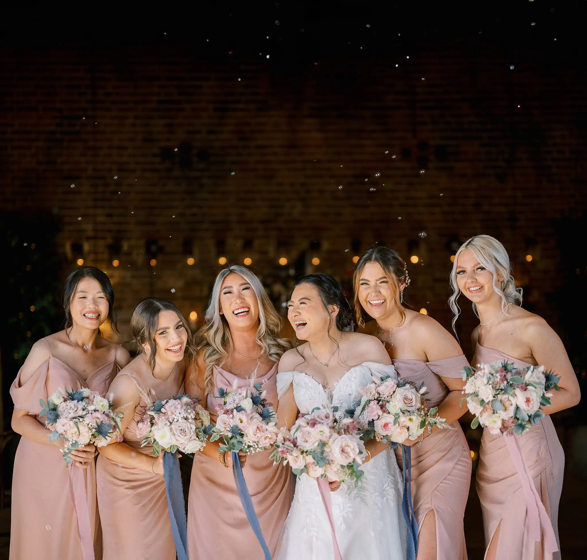bridesmaids laughing at hazel gap barn by yorkshire portraits