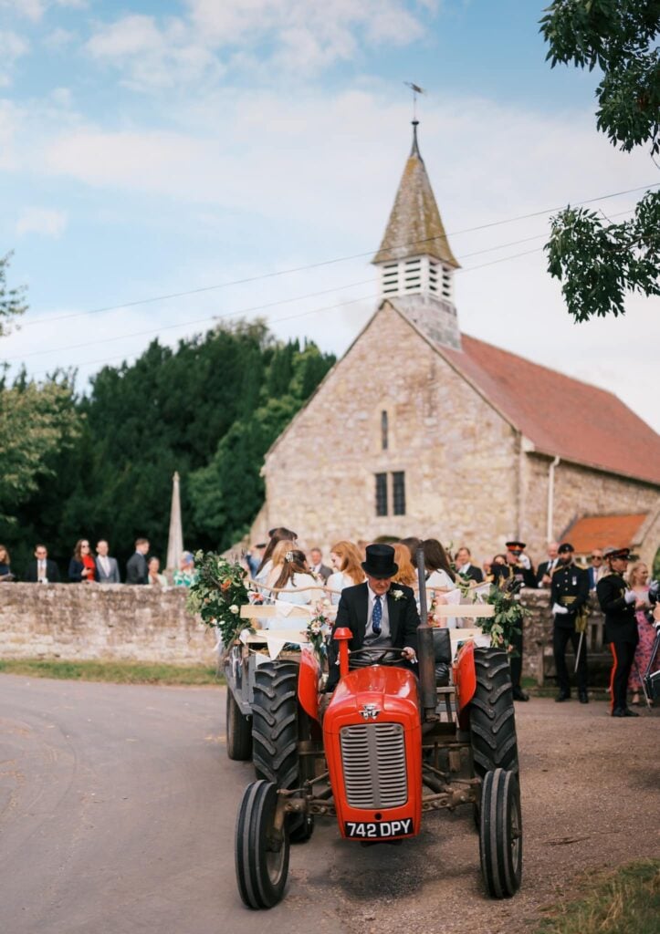 bridal party leaving church on an old fashioned tractor in north yorkshire near pickering