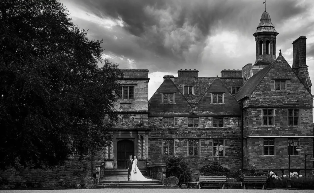 black and white photo f bride and groom in front of rufford abbey on their wedding day. rufford mill and abbey wedding photographer