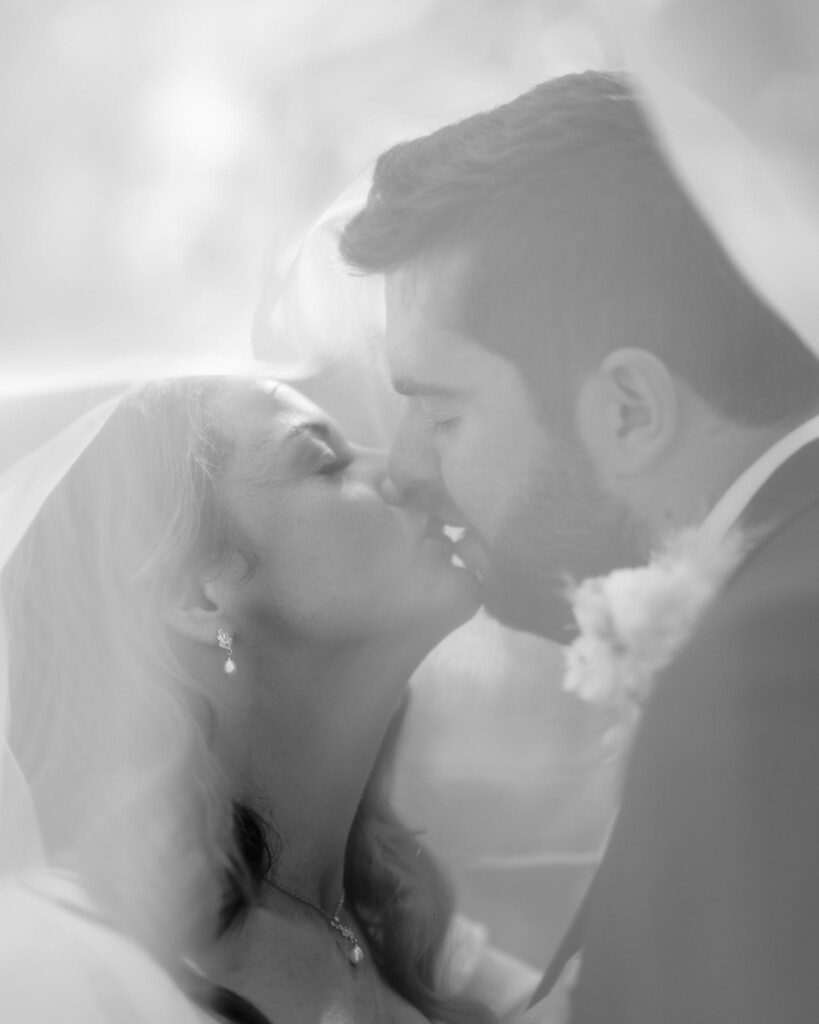 cockcliffe country house wedding photographer black and white photo kissing under veil