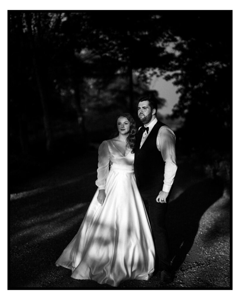 cockcliffe country house wedding photographer blsck and white photo of brideand groom holdinghands staring into a sunset