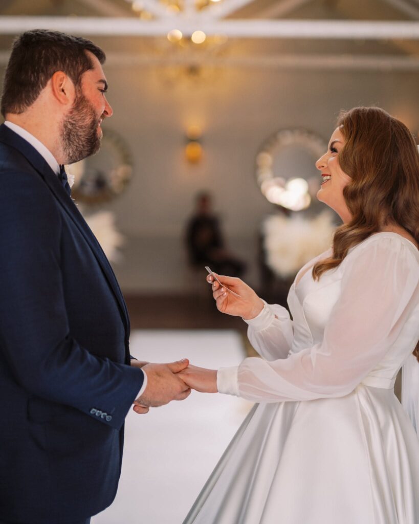 cockcliffe country house wedding photographer bride and groom holding hands during vows