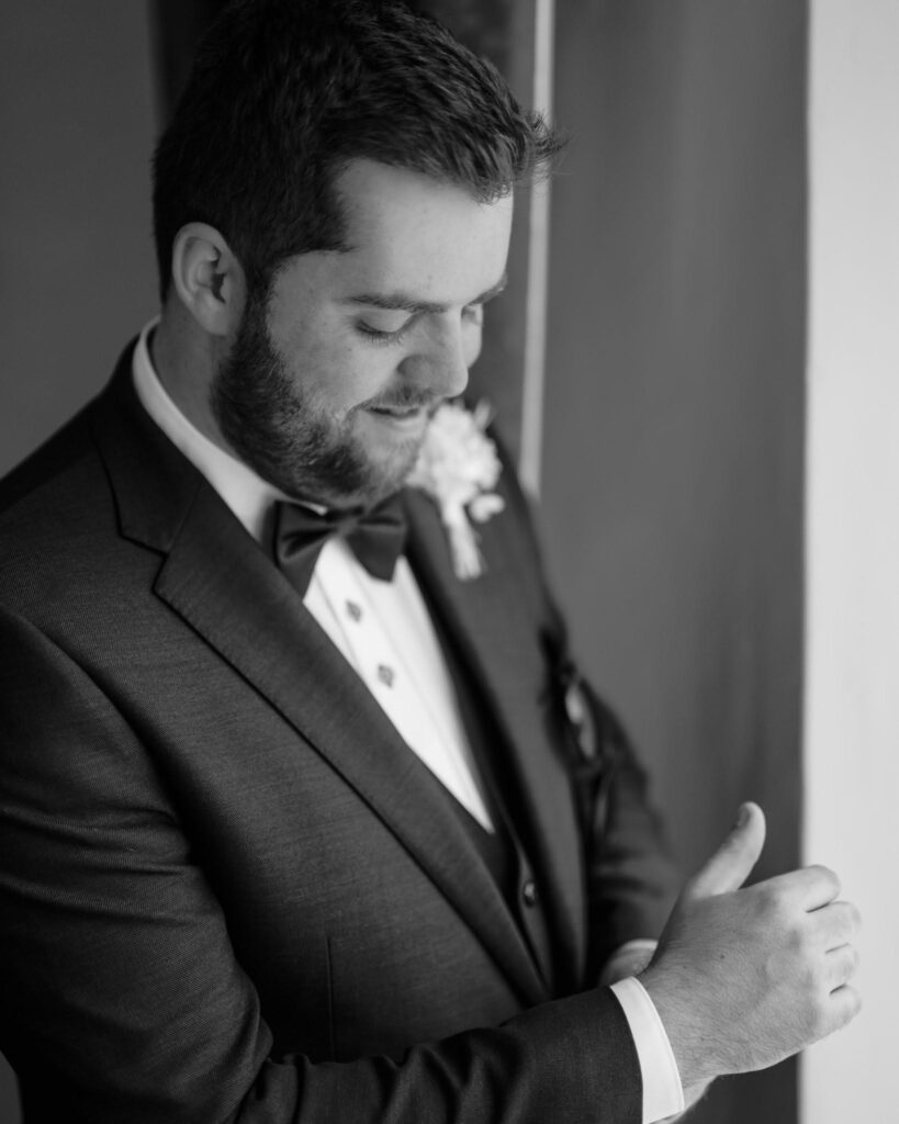 cockcliffe country house wedding photographer groom adjusting cuffs